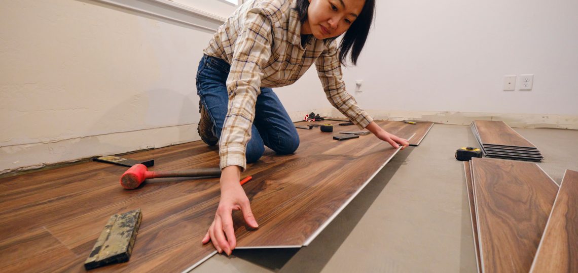 woman aligning wooden tile on floor